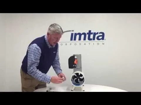 A still from Imtra: a man at a bench beside a tunnel thruster motor and its propellers, the Imtra name on the wall behind.