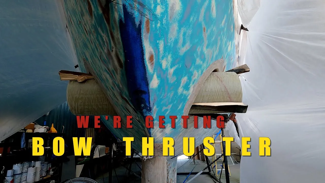 A still from Sailing Squalo: the bow of a sailboat on the hard, wrapped in plastic, titled We are getting a bow thruster.