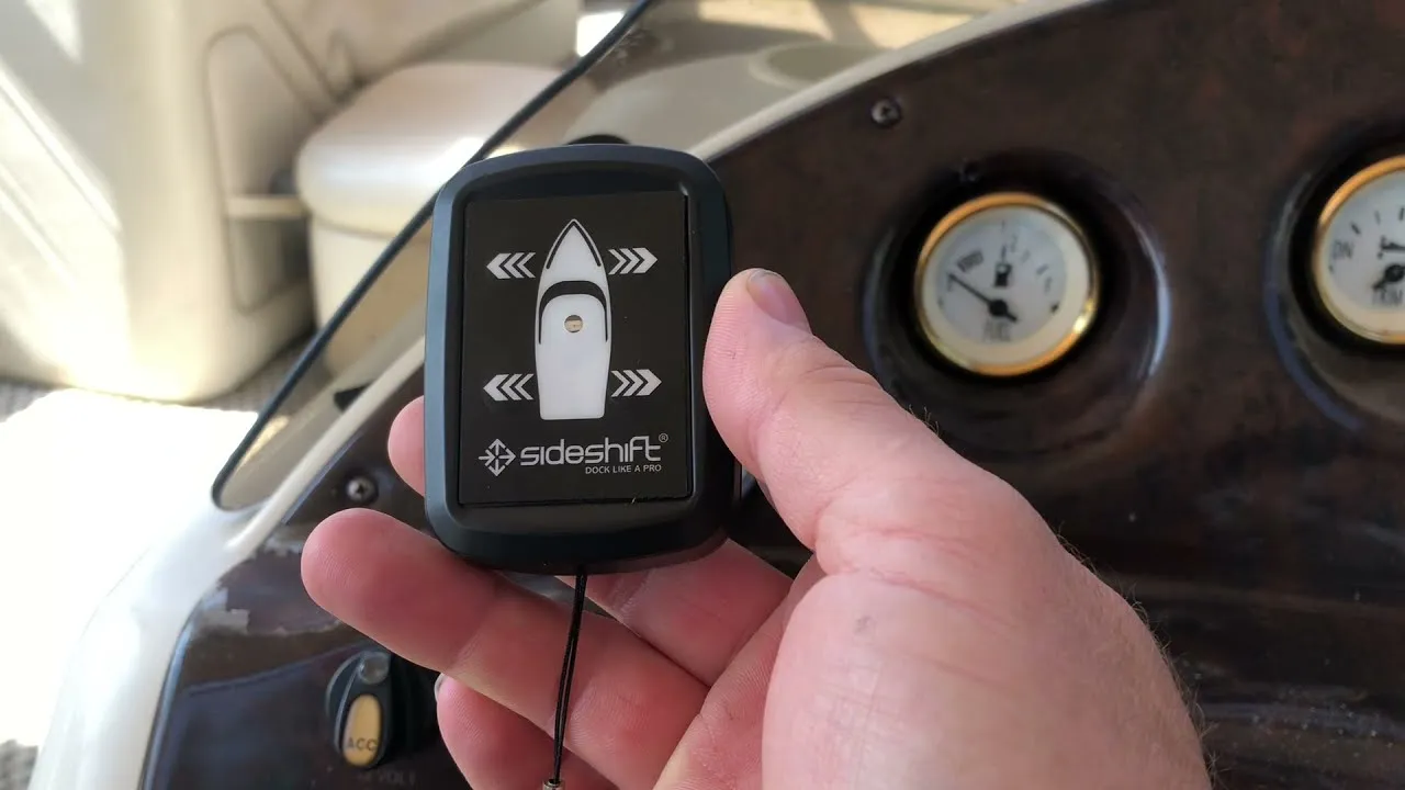 A still from Sideshift's pontoon video: a hand holding the wireless remote, a boat outline with arrows each side, at a pontoon boat's helm.