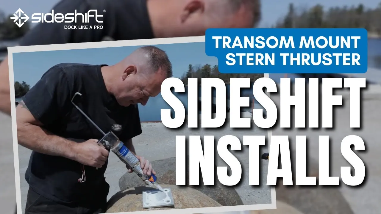 A still from Sideshift's transom mount video: a man with a sealant gun at a stern mounting plate on a rock by the water, titled Sideshift Installs.